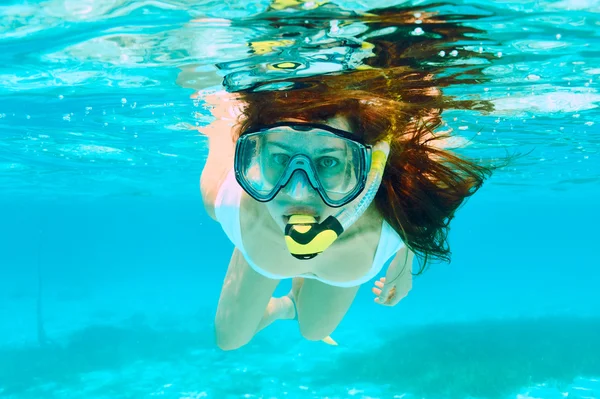 Woman with mask snorkeling