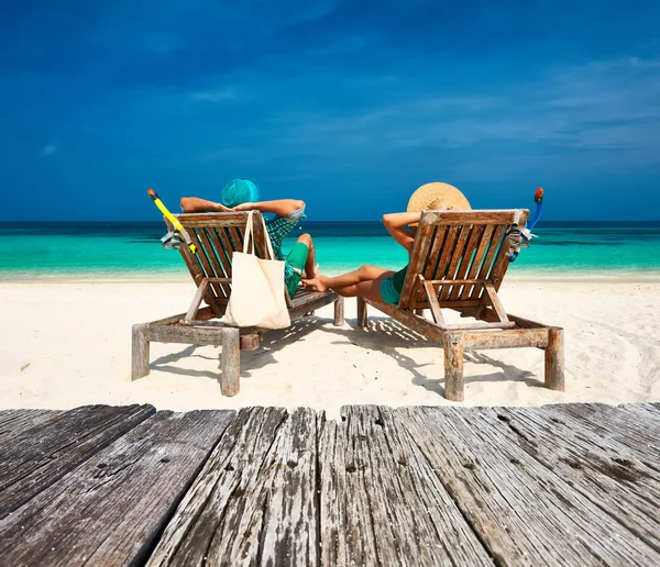 Couple relax on beach at Maldives