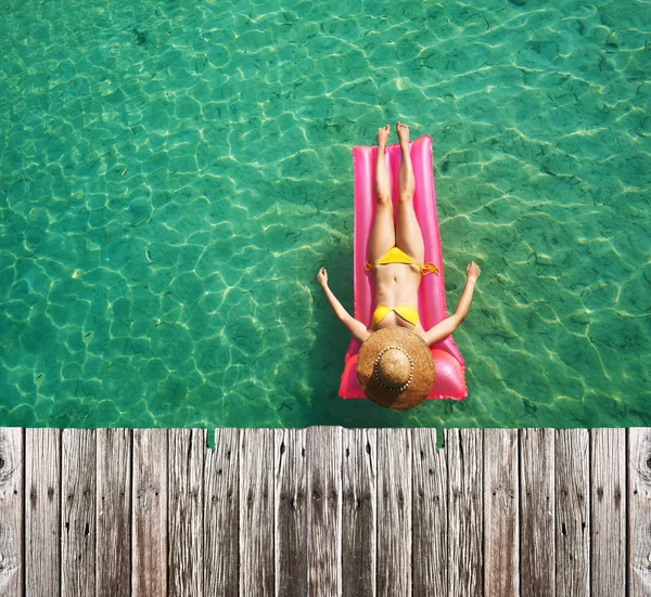 Woman relaxing on inflatable mattress