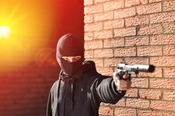 Gunman in mask with gun