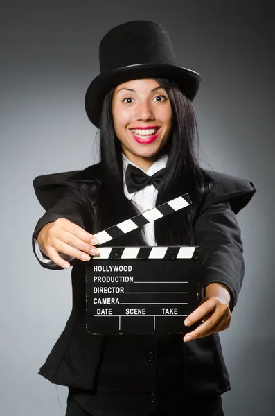 Woman with vintage hat and movie board