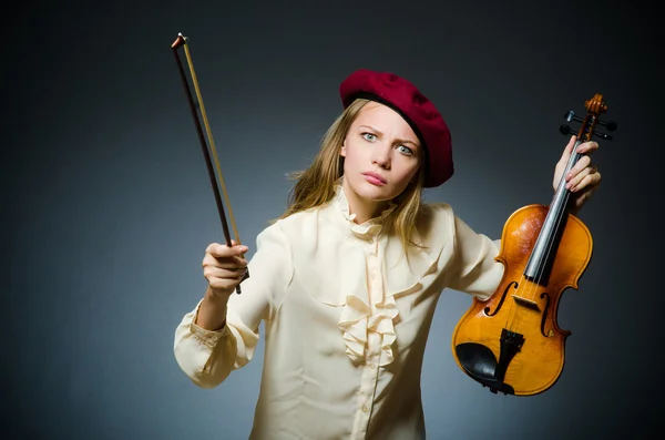 Woman violin player in musical concept