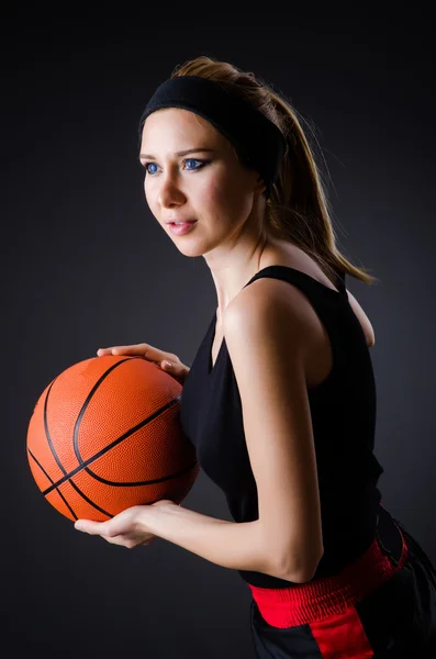 Woman with basketball in sport concept