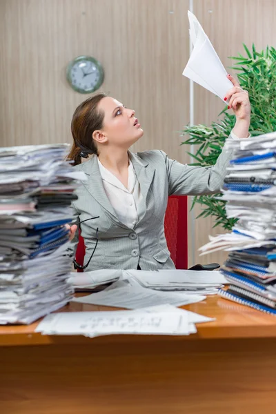 Woman under stress from excessive paper work