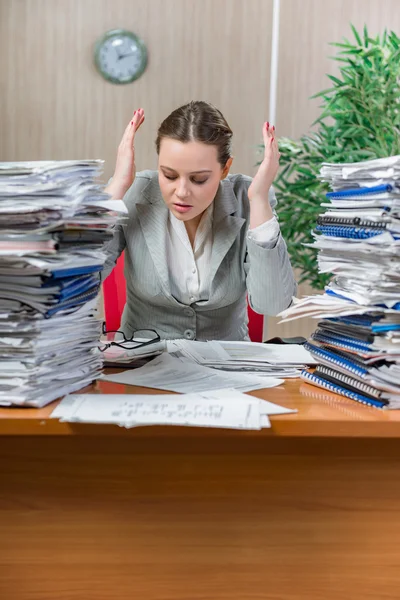 Woman under stress from excessive paper work