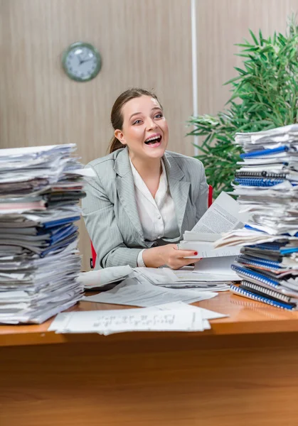 Woman under stress from excessive paper work