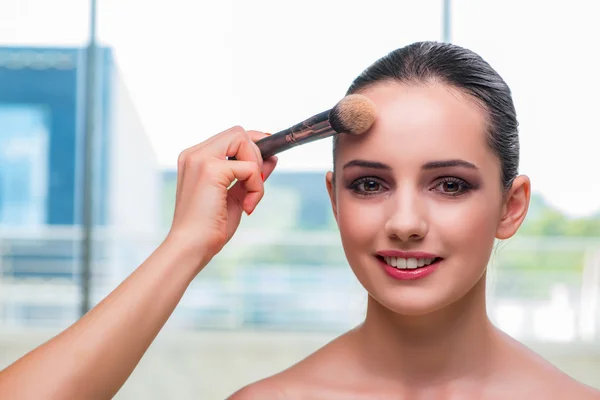 Beautiful woman during make-up cosmetics session