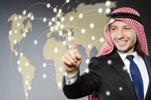 Arab man pressing dots on world map in global communication conc