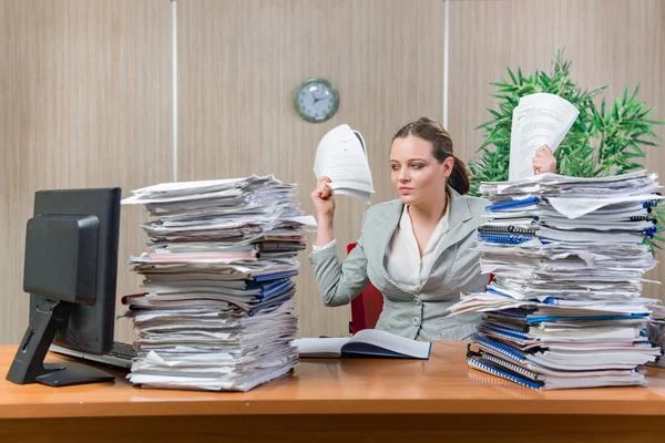 Woman under stress from excessive paper work