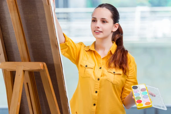 Young student artist drawing pictures in studio