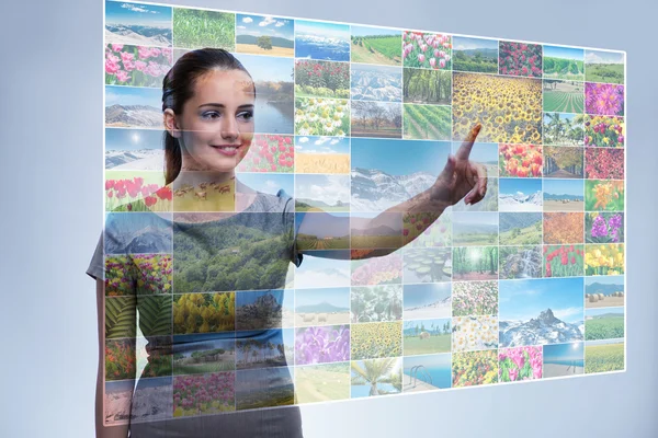Businesswoman pressing virtual button on nature collage