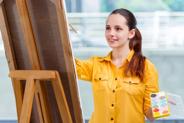 Young student artist drawing pictures in studio