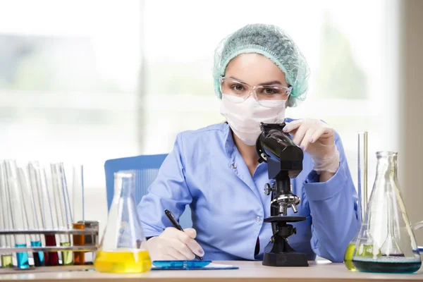 Experienced lab assistant working on chemical solutions