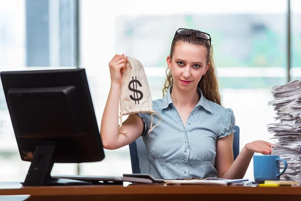Businesswoman with money sacks in the office