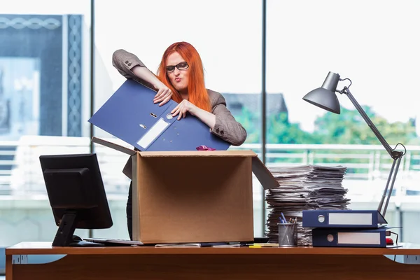 Red head woman moving to new office packing her belongings