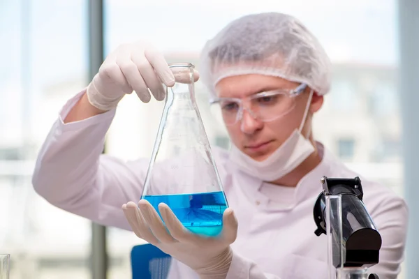 Man working in the chemical lab on science project