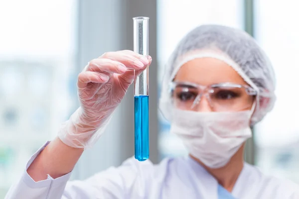 Young student working with chemical solutions in lab