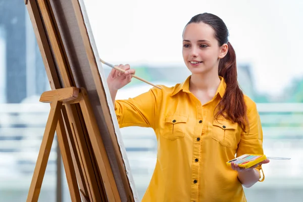 Young student artist drawing pictures in studio