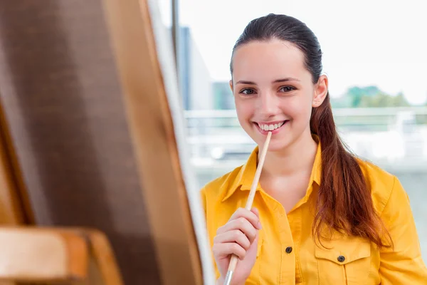 Young student artist drawing pictures in studio