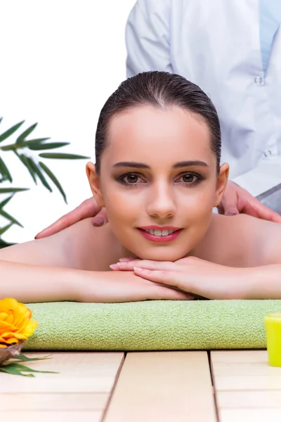 Woman during massage session in spa salon