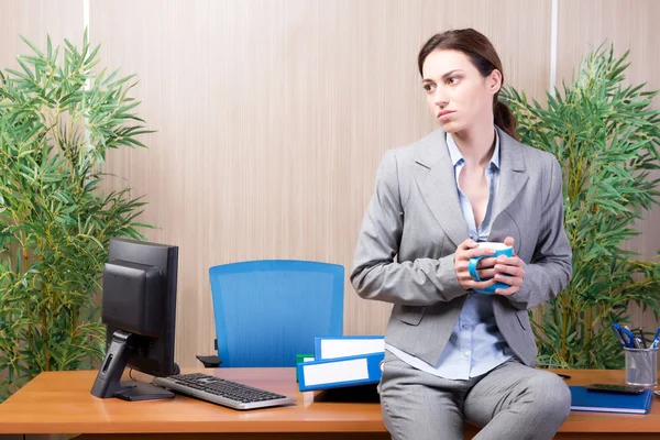 Woman under stress working in the office