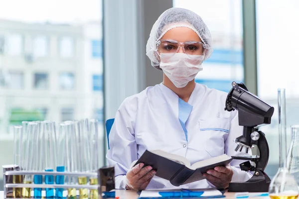 Young student working with chemical solutions in lab