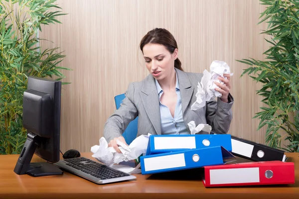 Busy businesswoman in the office under stress