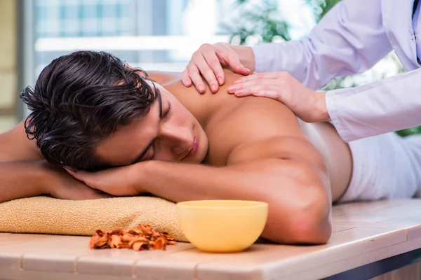 Man during massage session in spa salon