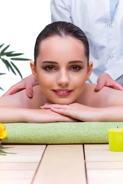 Woman during massage session in spa salon