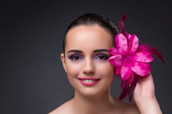 Young beautiful woman with orchid flower