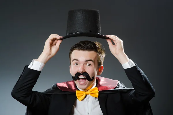 Funny magician with wand and hat