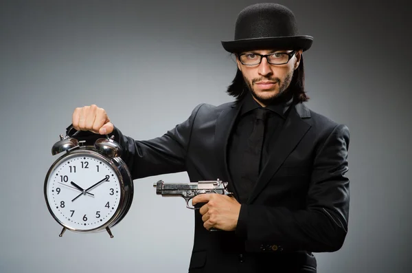 Man with clock wearing vintage hat