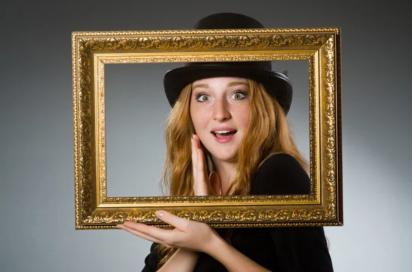 Woman with vintage hat and picture frame