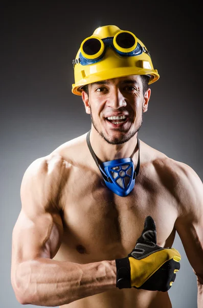 Ripped muscular builder man with tools