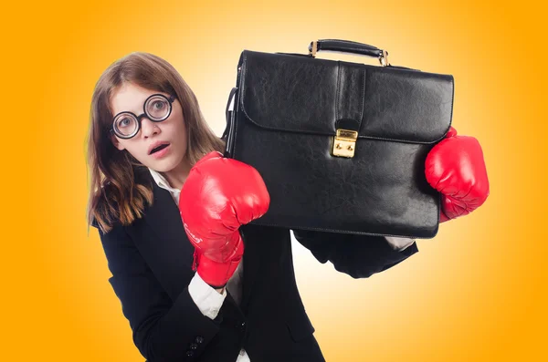 Businesswoman in red boxing gloves