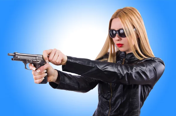 Woman in leather suit with handgun Stock Image Everypixel