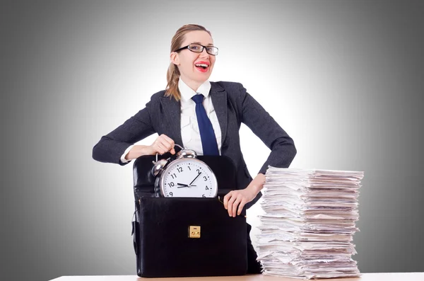 Businesswoman with clock and papers