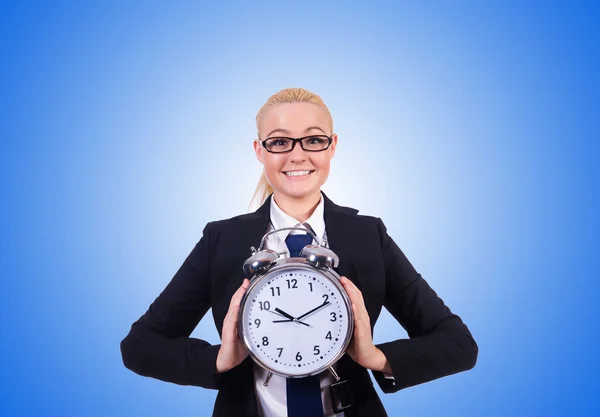 Woman with giant clock against the gradient