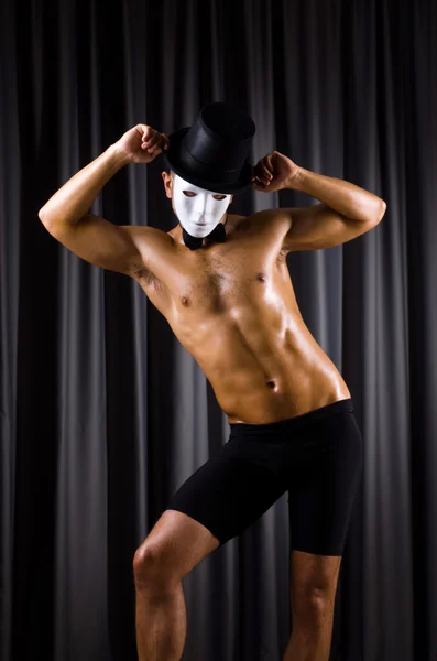 Muscular actor with theatrical mask