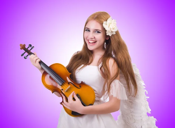 Young violin player isolated on purple