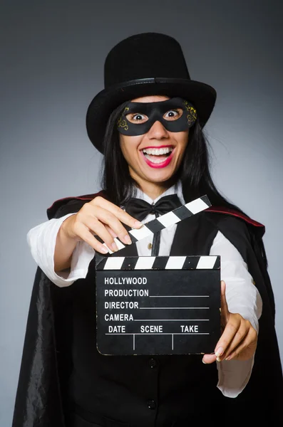 Woman wearing mask with movie board