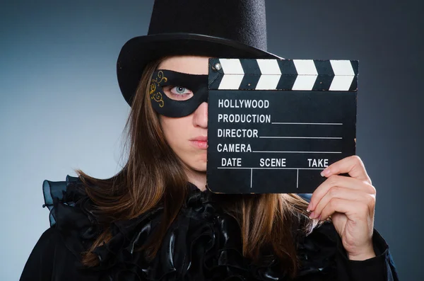 Woman wearing mask with movie board