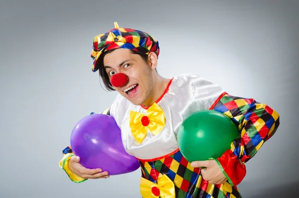 Clown with balloons in funny concept