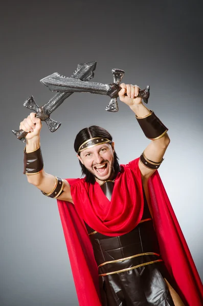 Roman warrior with sword against grey background
