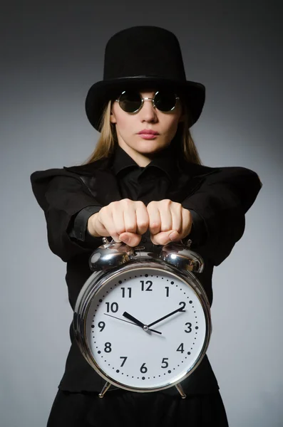 Woman with clock in business concept