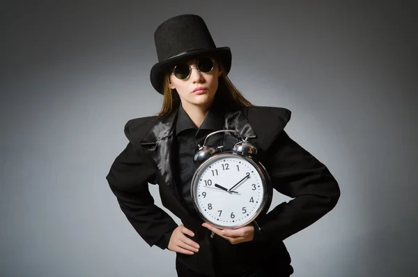 Woman with clock in business concept