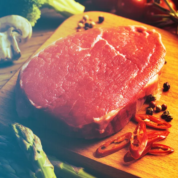 Raw Steak with green asparagus