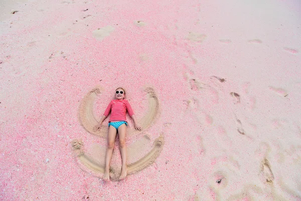 Girl making sand angel