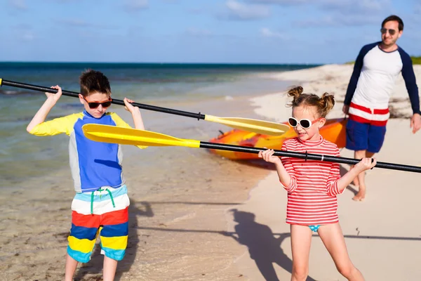 Family kayaking at tropical ocean