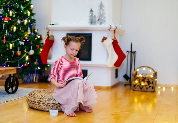 Little girl at home decorated for Christmas